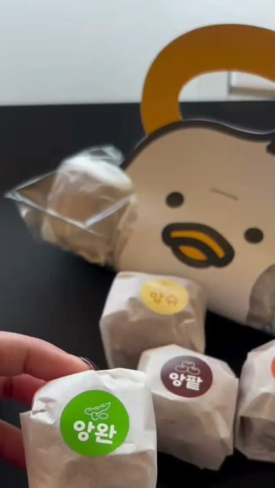 Individually wrapped ANGHODU cakes with flavor stickers