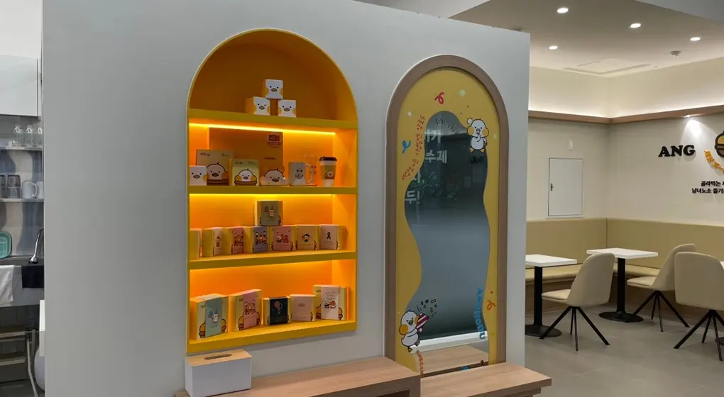 Arched display shelf lit from within, with seating beyond