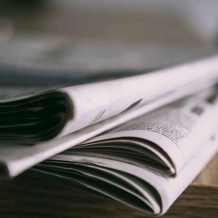 A stack of folded newspapers